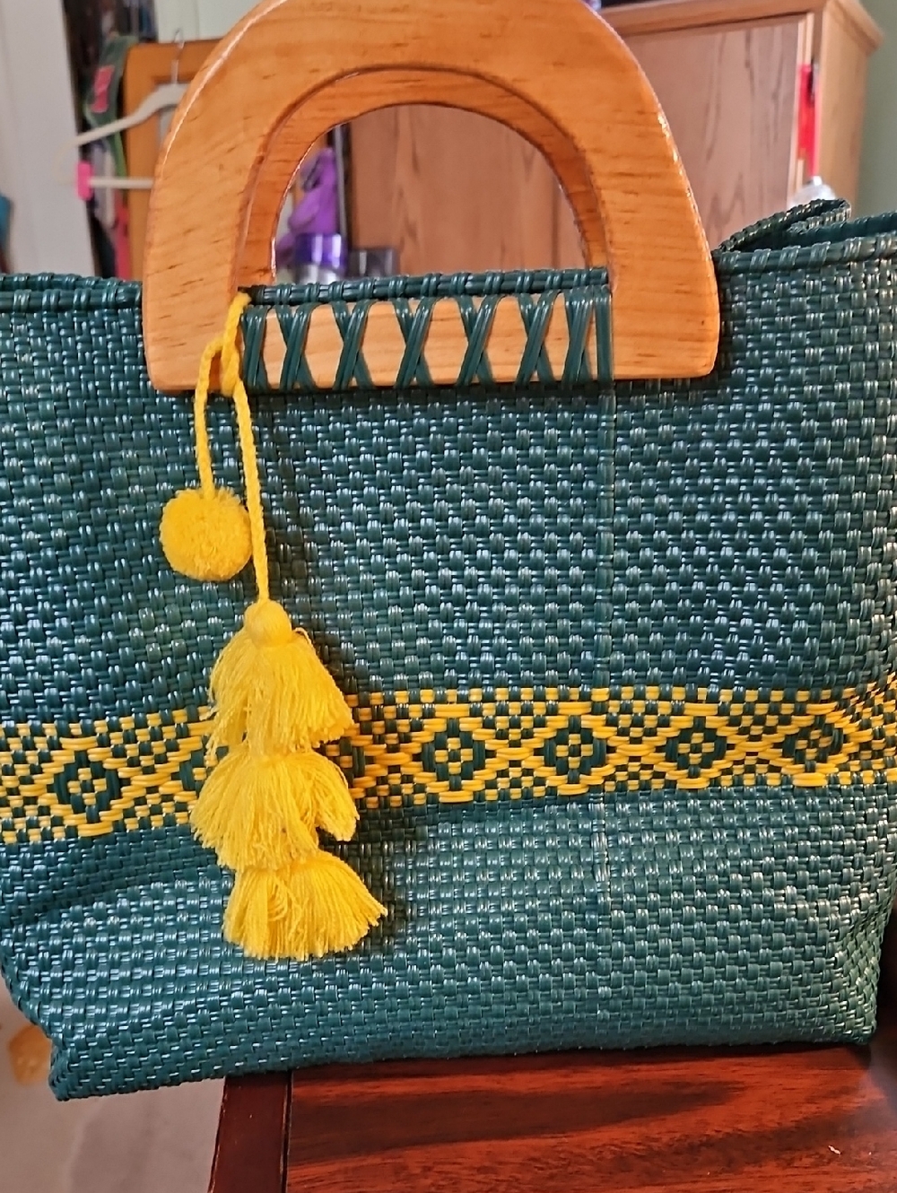 Woven Green Tote Bag with Yellow Tassel Accent
